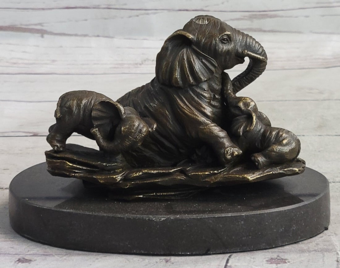 Elephant with Two Baby Calf Bronze Sculpture: The Elephant family celebrates the unbreakable bond between mother and child. the artist captures a sweet moment between mother and child and uses the lost-wax method to cast these figures from molten