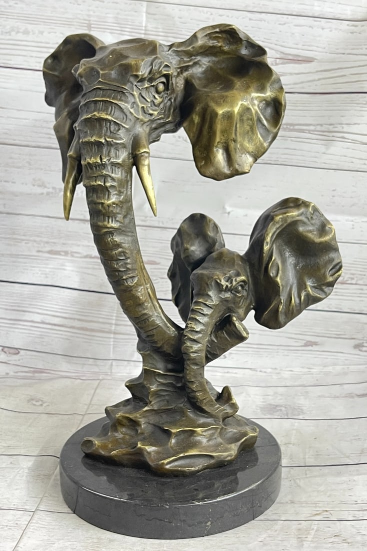 Elephant and Calf Bronze Sculpture: Ganesha Is A Hindu Deity With An Elephant's Head. This Bronze Sculpture Was Captured Using The Ancient Method Of Lost-Wax Casting And Stained With A Brown Patina Finish For Preservation. Dimensions: H