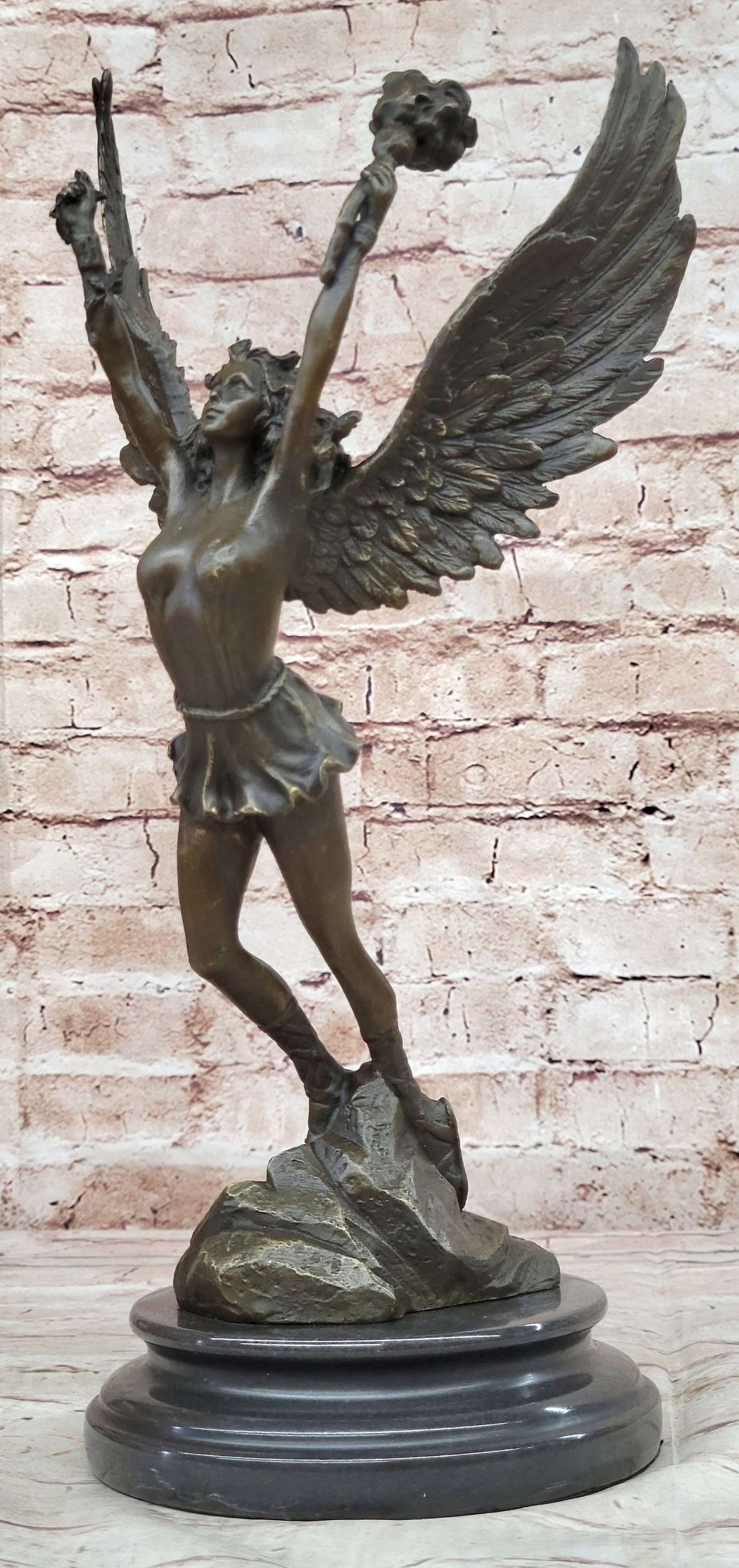 Venus Goddess of Love Bronze Sculpture: An angel stands boldly. She hails from the heavens and fights for the salvation of our world as well as his from darkness of any form. She wears a robe and sandals, carrying a torch with her wings