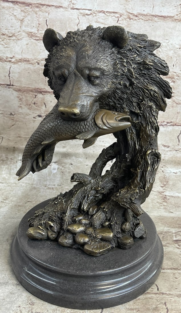Bear Head Bust with Fish Bronze Sculpture: This is an interesting bust honoring the majestic bear. It composes the bear so that it is essential is entwined with that of nature; of the fallen trees, of the water-smoothed pebbles, it is paws car