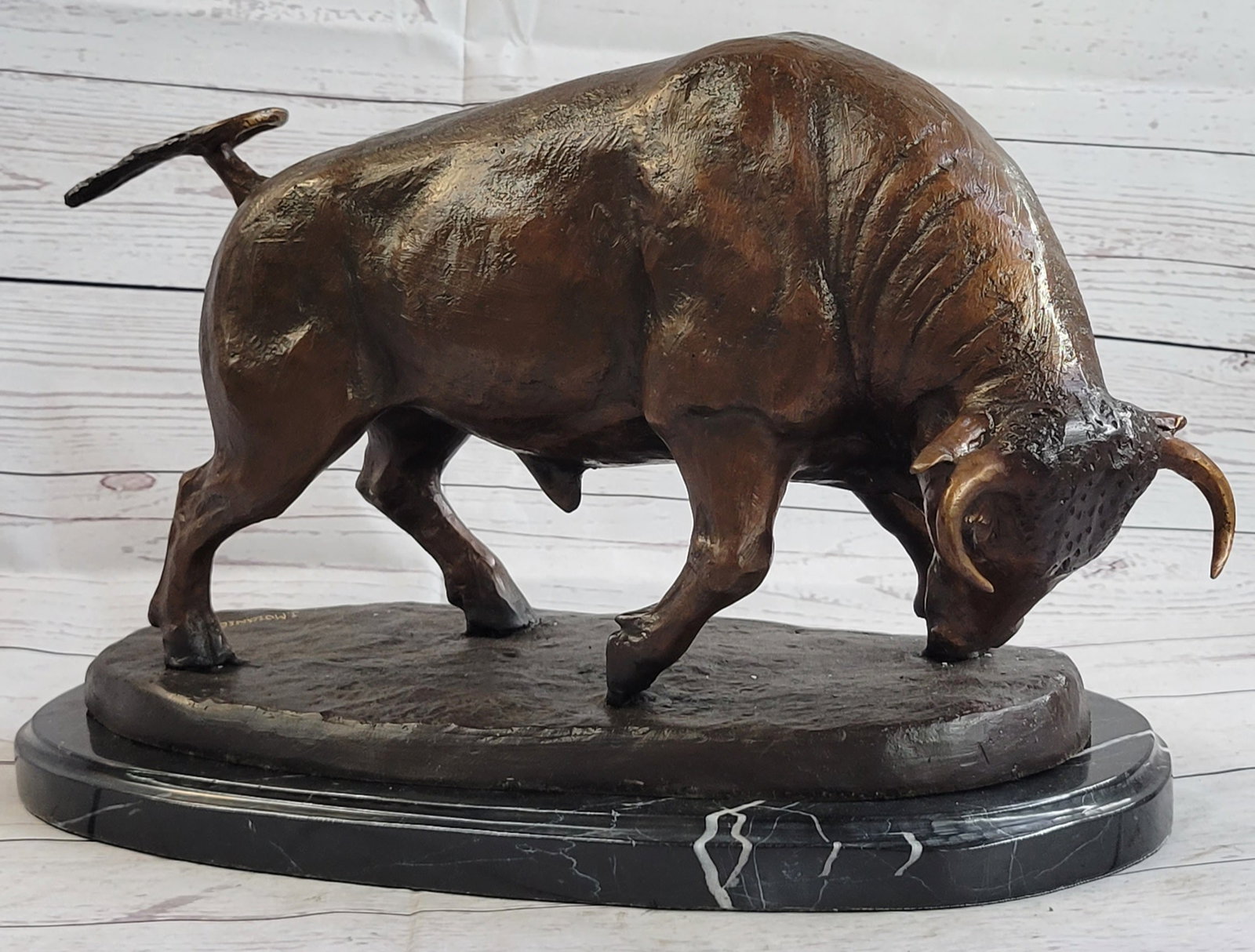 Stock Market Bull Bronze Sculpture: This magnificent Sculpture is of a charging bull. With his head down, his nostrils flared and his muscles tightened he stomps the ground before him, releasing a vibrating grunt, he smells the ground b