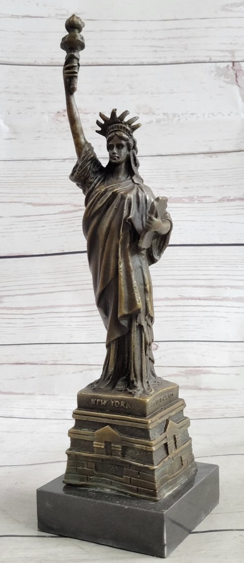Liberty Bronze Statue: This sculpture was cast using the Lost Wax Method and has a brown painted patina. Dimensions: Height 10 X Width 3 inches. Weight: 3 LBS.