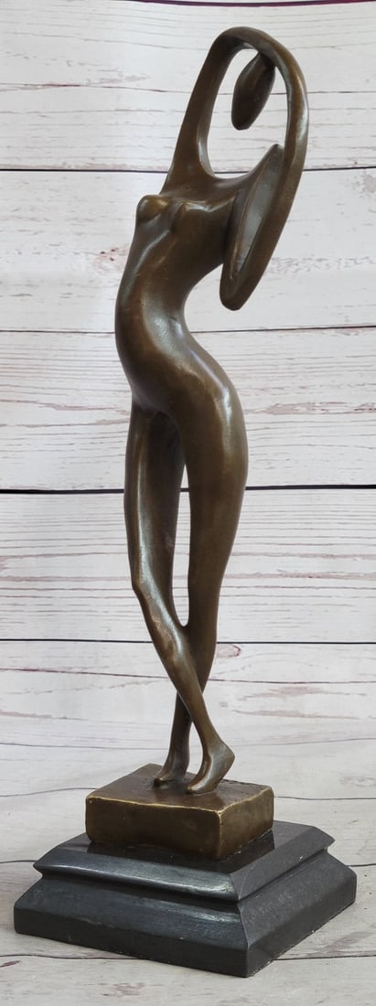 Modern Art Nude Bronze Figure: The suggestive female form pulls out of the base from the hem of a fanned skirt that evolves into the definition of her bent leg. Her arms both rest on her head; one in the shape of an angle while the