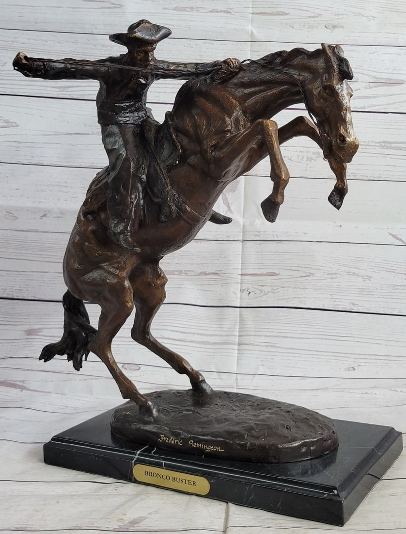 Bronco Buster Bronze Sculpture on Marble Base Stand: A Seasoned cowboy courageously rides his wild horse. His uncontrollable stallion backs him but his grip on the reins never breaks. His body rolls with every move of the horse. He is dressed in a Shirt