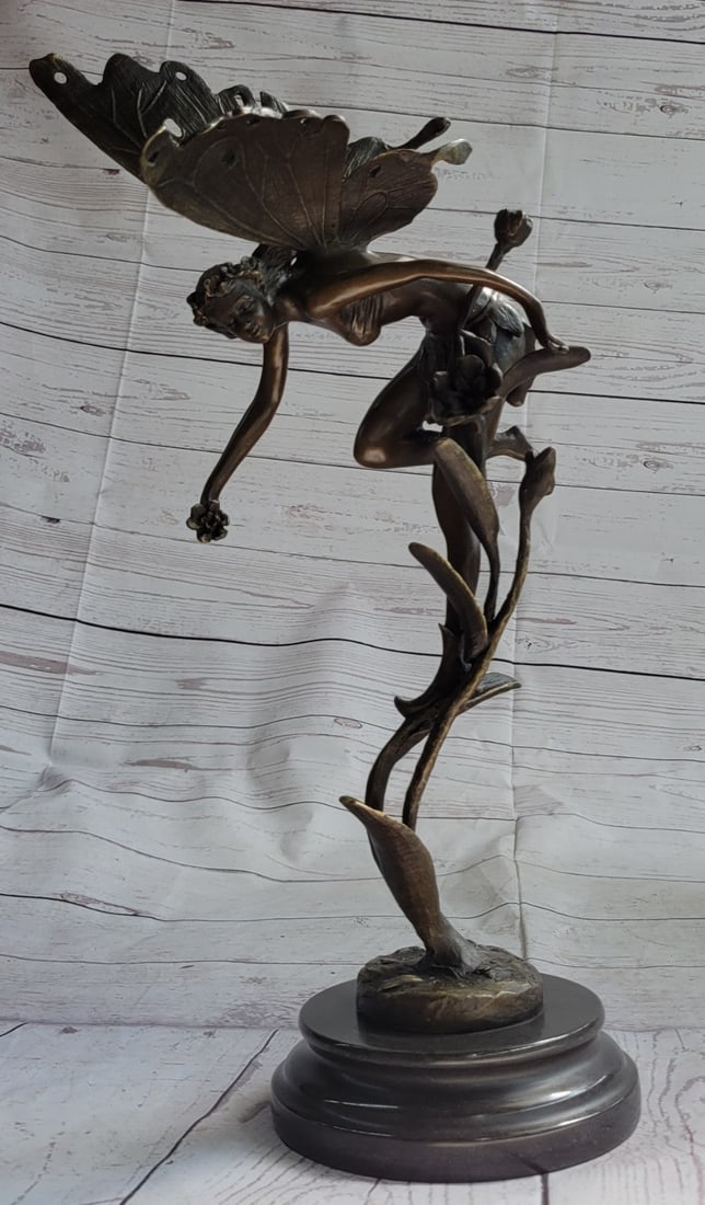 Mythical Bronze Fairy Angel Sculpture: An Fairy Flies from Heaven. She hails from from the heavens and fights for the salvation of our world as well as his from darkness of any form. She wears a robe and sandals, carrying a message with he