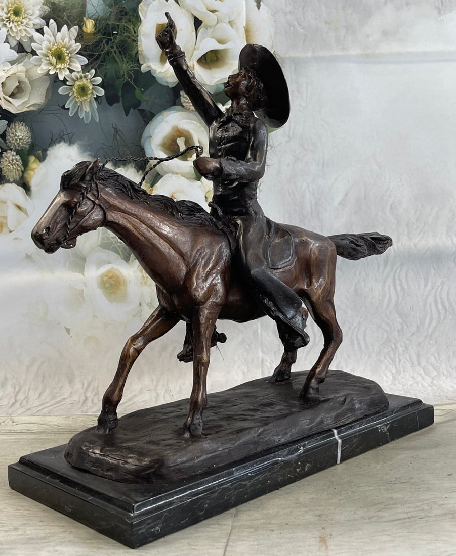 Pony Express Cowboy Bronze Sculpture: This is a Statue of a cowboy, revolver in hand, aimed at the sky as he rides on his trusty horse. He is dressed in blue jeans with chaps and a buttoned-up shirt with a bandana loosely tied around his 