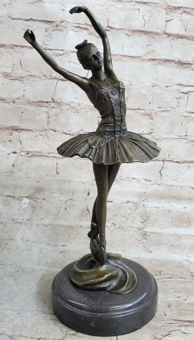 Prima Ballerina Dancer Bronze Sculpture: A prima ballerina puts on a show. Well trained in the art that she loves, she shows off her agility, balance, and flexibility. She elevates her long leg far behind her. Her chest pushes out and her he
