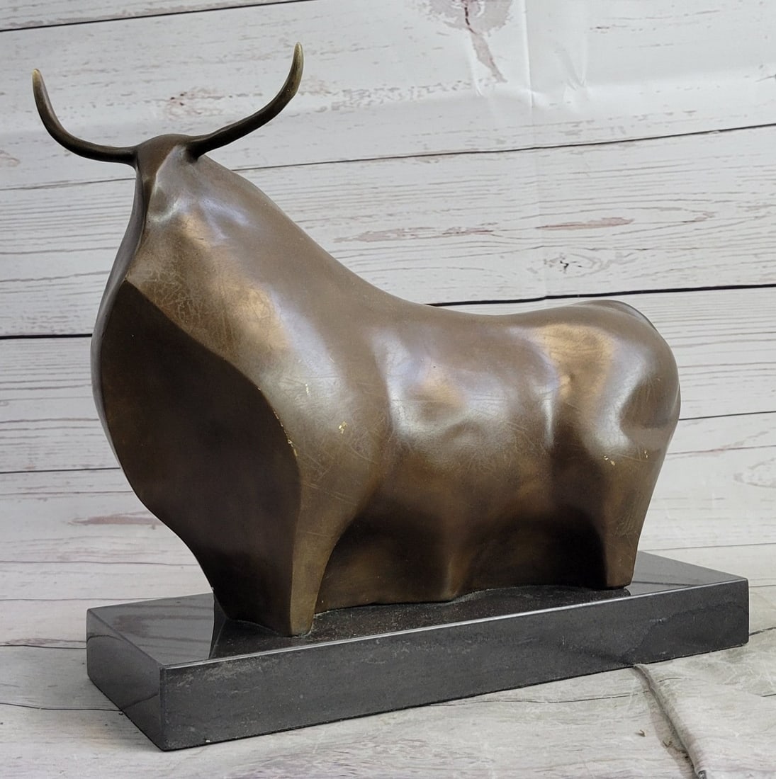 Modern Art Bull Bronze Sculpture: The sculpture is using the Lost Wax Method and a two-toned brown patina is used and he rests on a marble base. Dimensions: Height 11 X Width 13 inches. Weight: 14 LBS.