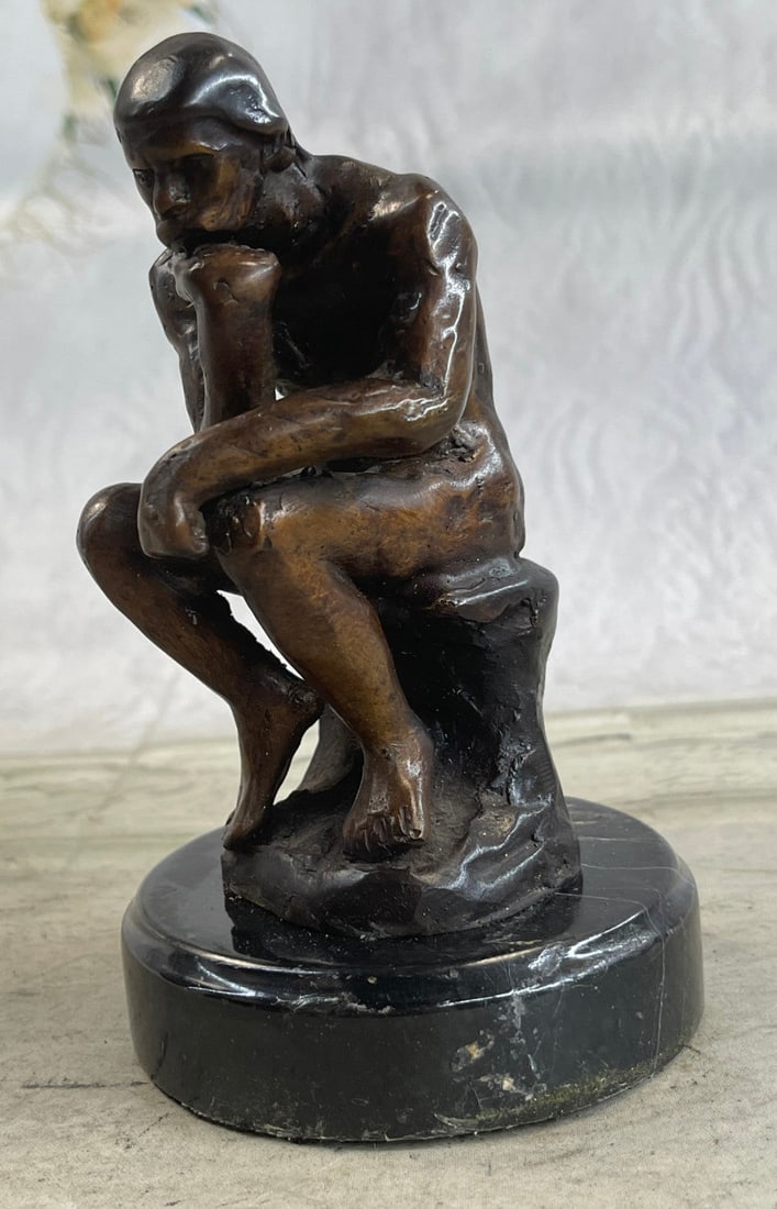 Elegant Bronze Statue: The Thinker is depicted as a man in sober meditation battling with a powerful internal struggle. The unique pose with hand to the chin, right elbow to the left knee, and crouching position allow the