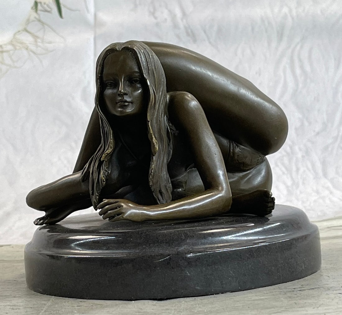 Nude Girl Bronze Sculpture: With extreme grace and expertise, our beautiful exotic dancer extends her leg back and up folding them behind her head. Showing great flexibility and contortionist she twists and turns her nude body a