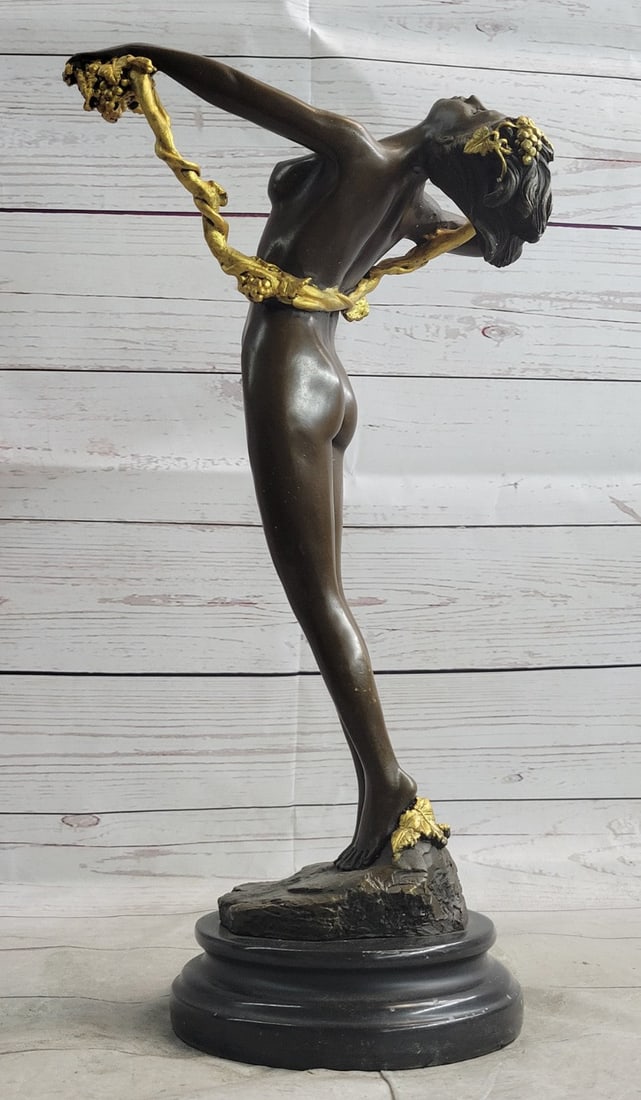 American Art Nouveau Vine Bronze Sculpture: The nude beauty leans far back from the rush of ecstasy that surges from her head to her toes. Amidst the airs of nature, she holds her roped hair in her left hand offering it to gravity. Her hair see