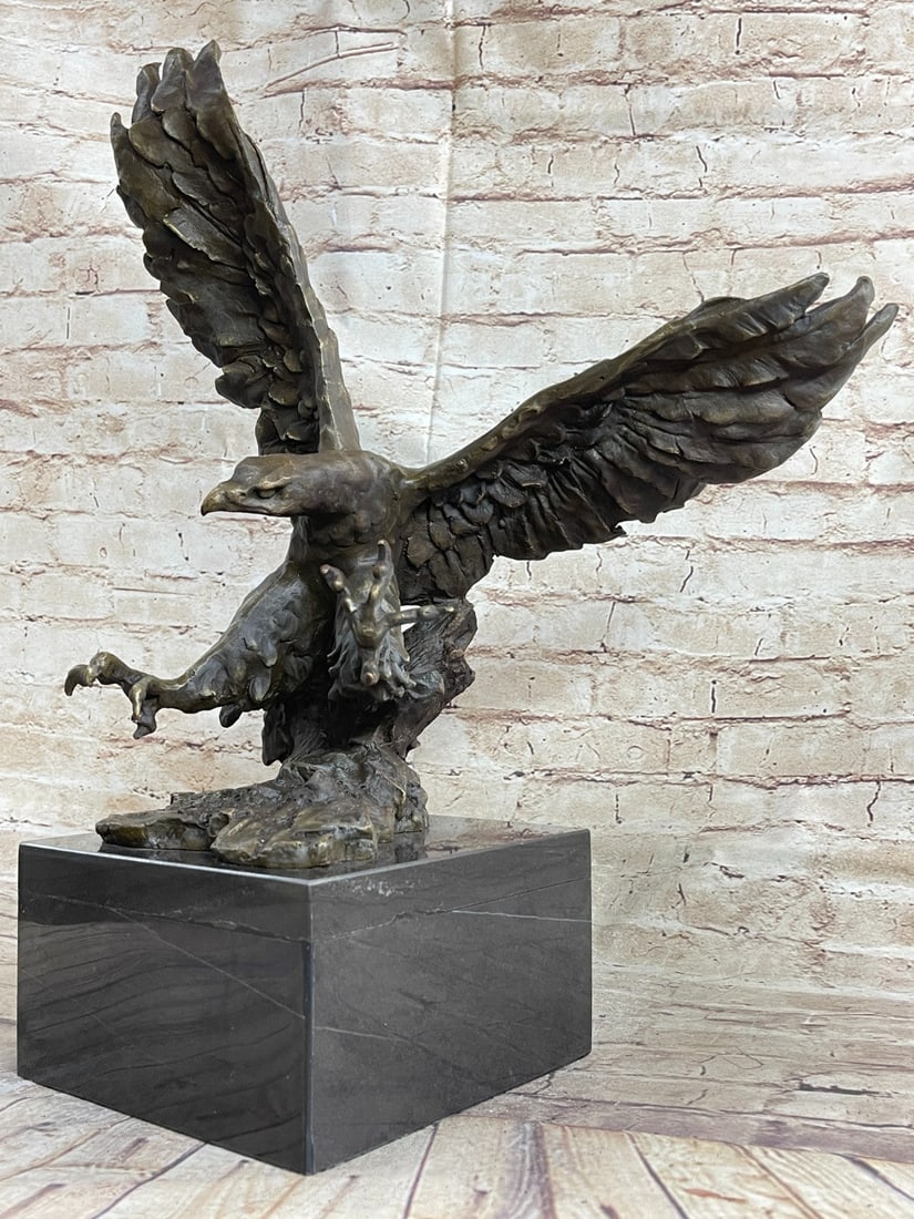 Landing Action Figural Bronze Sculpture: A large eagle descends and is preparing to land down. His clawed feet spread ready to grip onto the landing. The eagle\'92s expansive wings, designed with exquisite detail, flap high in the sky as