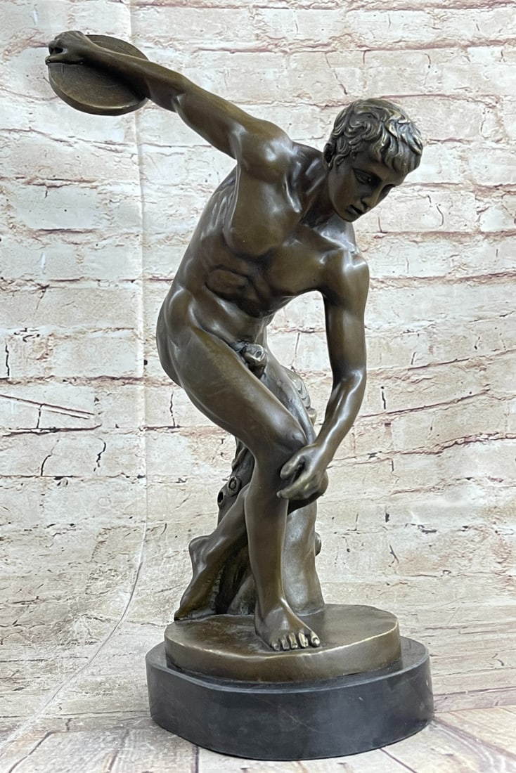 Greek Discobolus of Myron Bronze Sculpture: This sculpture was cast using the early method of lost-wax casting and stained with a brown patina finish for preservation and mounted upon a marble base. Dimensions: Height 16 X Width 11 inches. Weig