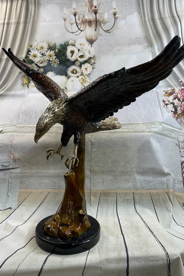 American Eagle Bronze Sculpture: This is a beautifully detailed Sculpture of the American bald Eagle. It swoops down from the sky and spreads his wings and claws to grasp a nearby branch. He swoops down and is versatile in this