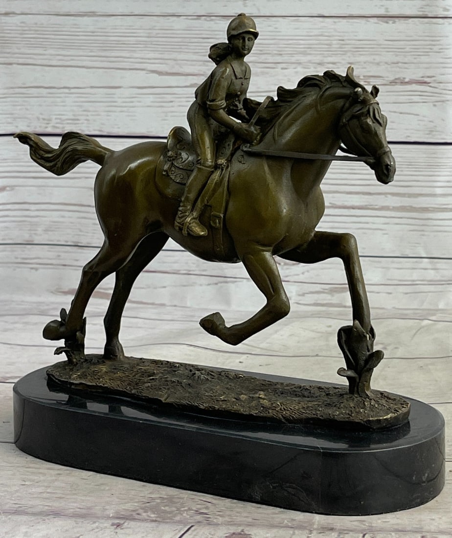 Jockey Racing Horse Bronze Sculpture: The Female jockey and horse, a team of speed, as she is petting her lovely friend. The horse stands elegantly while the jockey seems to be captured in a moment of reflection perhaps reviewing the