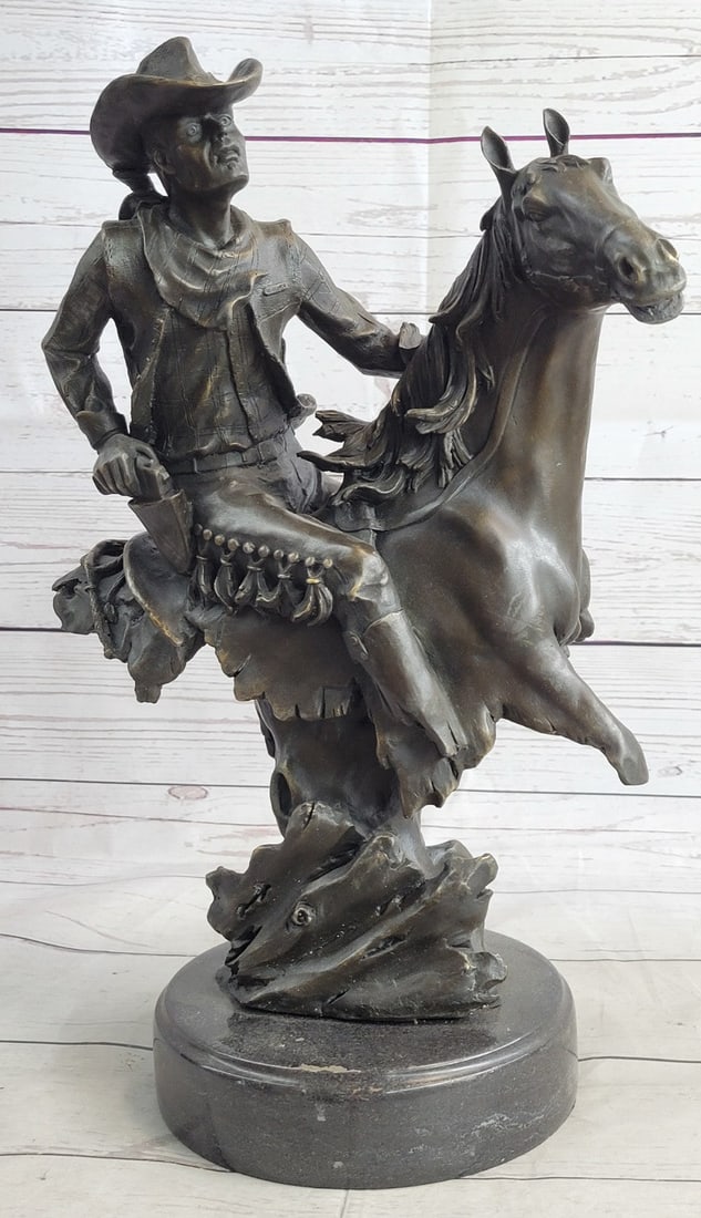 Outlaw Cowboy Horse Bronze Sculpture: The outlaw in the wild west holds the reigns tight, twists back, and fires a gunshot to his enemy that is closing on his tail. He appears steady on the fast-moving horse. This cowboy is no amateur. Th
