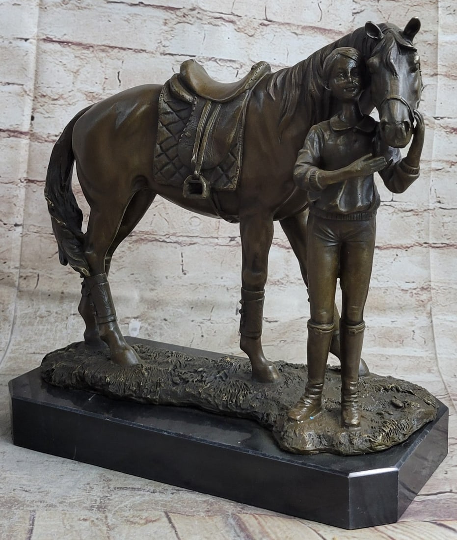 Jockey with Racing Horse Bronze Sculpture: The Female jockey and horse, a team of speed, as she is petting her lovely friend. The horse stands elegantly while the jockey seems to be captured in a moment of reflection perhaps reviewing the race