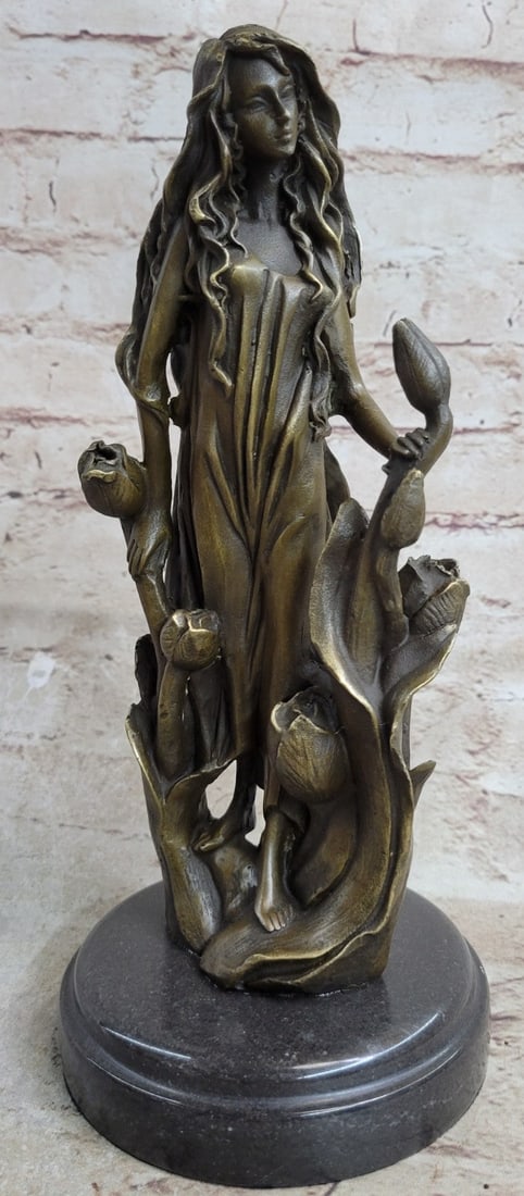 Flower Girl Bronze Sculpture: This beautiful woman sits in the midst of a gorgeous flower garden and picked a bunch of different ones for her home. She has an amazing long yet sexy dress that reveals her legs. The beauty sits look