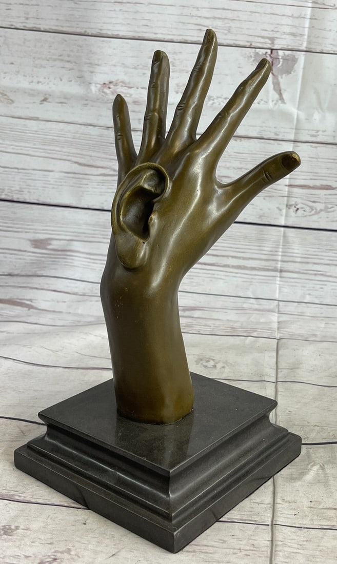 Walls Have Ears Bronze Sculpture: This work of art is fantastic to the last little detail. Each line crafted to perfection, from the fingers to the fingernails and hand cuts. This Sculpture is very Unique because it has an ear stick o