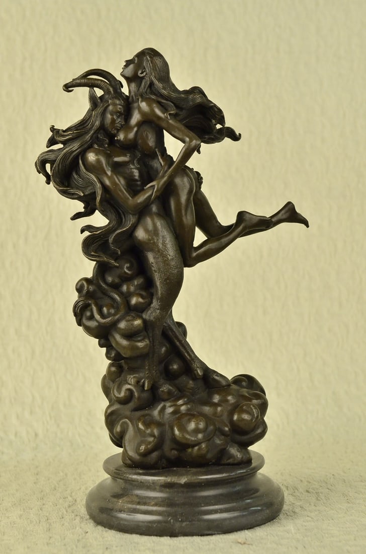 Devil With Nude Girl Bronze Sculpture: Making it even more unusual is one of the satyr's legs has a hoof at the end, which you would expect to see on a satyr sculpture that is half man half goat, but he is right foot is sculptured in