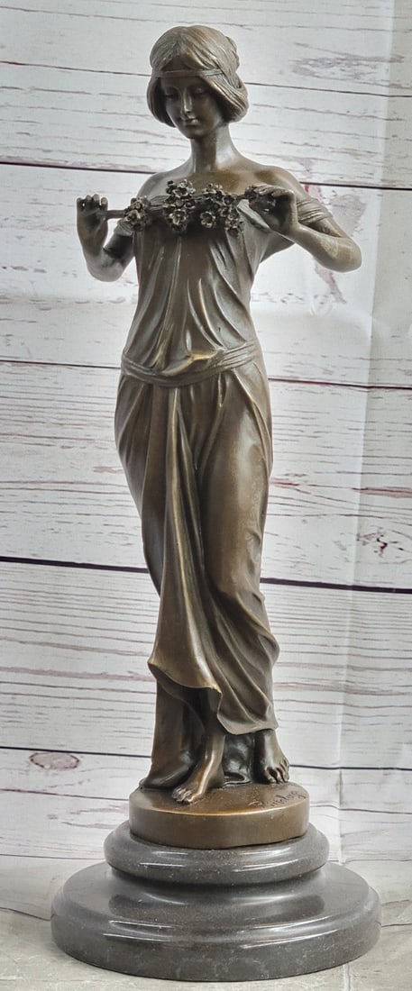 Nymph of the Woods Bronze Figurine: Nymph of the Woods Bearing the bounty discovered on a morning lark in the Italian countryside. Artistically sculpted from her stylish headdress to the soft drape of gown across her slender body. This