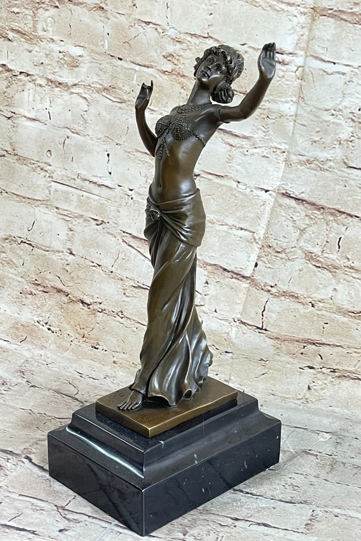 Young Woman Bronze Sculpture: This beautiful sculpture of an Indian lady dancing is amazing in details from her dress to her face. She wears this long one piece short sleeve dress, with a beautiful gold vest and belt that comes wi
