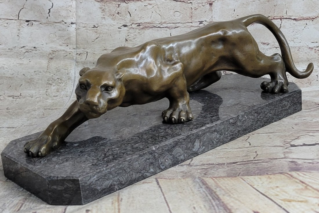 African Lion Wildlife Animal Bronze Statue: A lioness wanders through her wild African habitat after chasing away a predator from her cubs. She is fierce yet nurturing, ready to fight to the death to protect herself or her young. The deep carvi