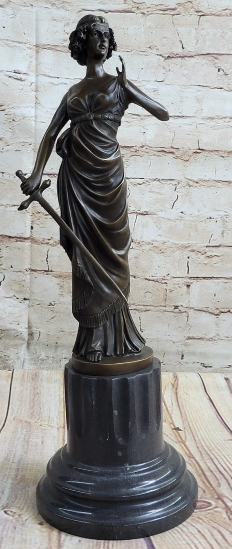 Roman Greek Warrior Bronze Statue: She stands tall with grace, strength, and pride. She clutches her sword and gazes out into the distance. She wears a long dress that gathers at her hip. This brown patina Sculpture was cast using the 