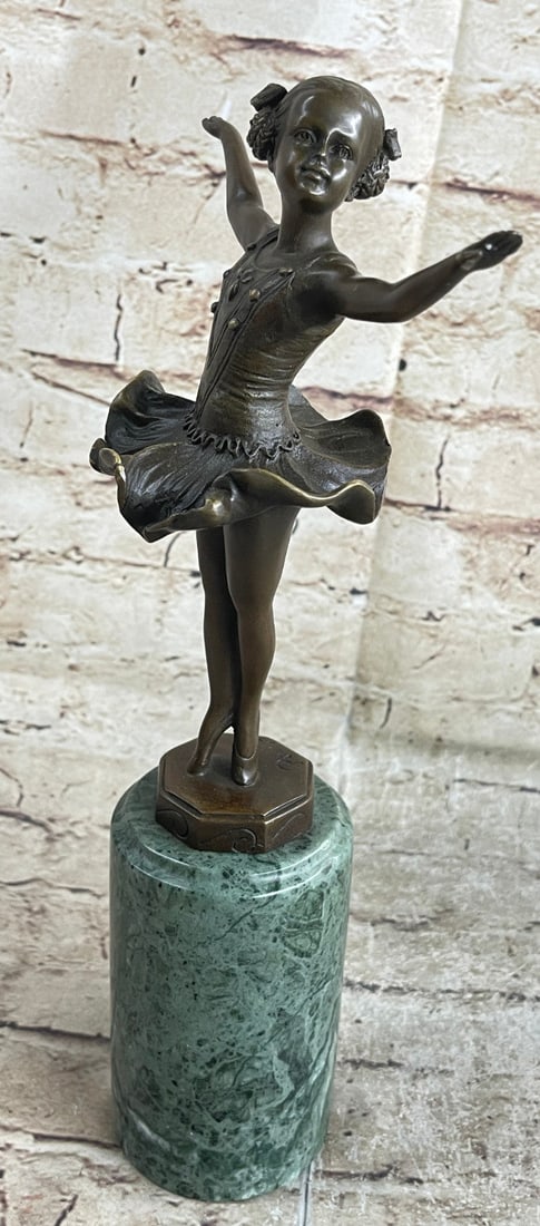 Classy Girl Ballerina Bronze Statue: A young girl dances for a loving crowd. She raises her ballerina arms out to her sides and twirls on the tips of her tiny toes. Her tutu frills billow around her. Still so young, she is already a tale