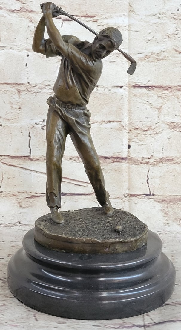 Male Golfer Golf Sport Bronze Sculpture: A golfer tilts her head up to the sun and watches her ball rise. She holds her form and stance, tracking the position of the ball and how close to the green it may land. Her body twists with her strok