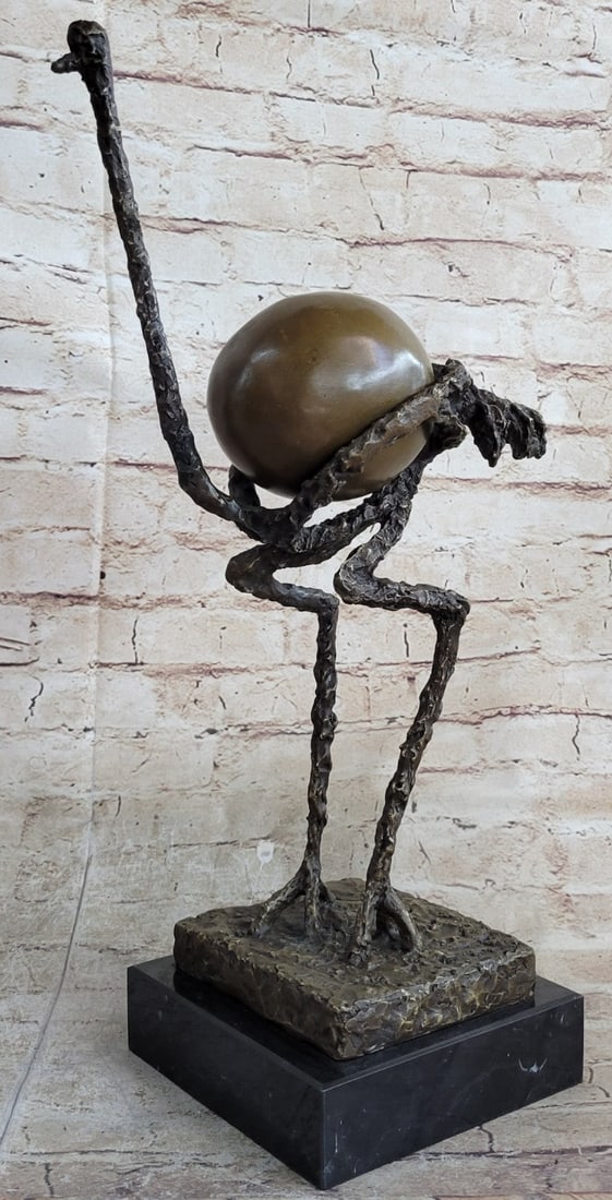 Figurative Abstract Ostrich Bronze Sculpture: The figurative abstract ostrich was envisioned by the artist as deteriorated by space and diminished until it is in its skeletal frame. The texture seems to be that of wet concrete which creates a