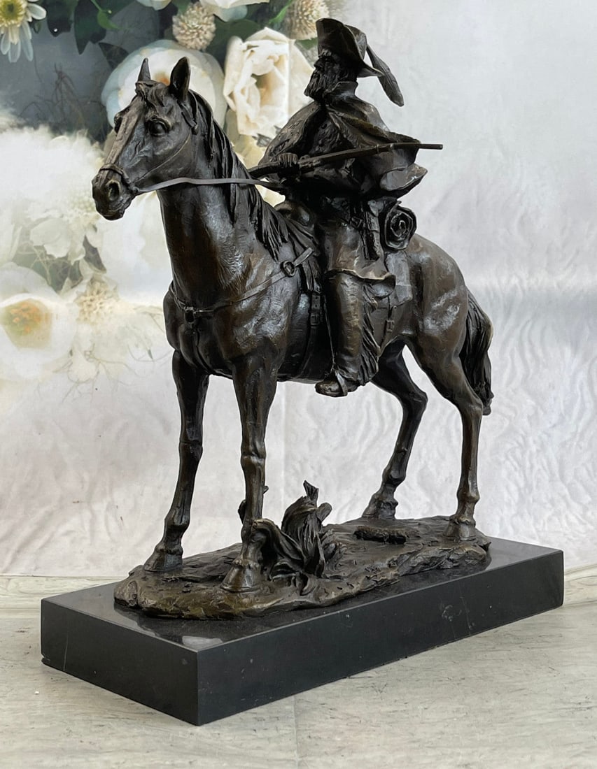 Cowboy With Riffle on Horse Bronze Sculpture: A Cowboy Charges Across The Dry Land With His Gun In his hand. His Horse Gallops, With Its Nose Pointed Forward. The Cowboy Holds The Reins Tightly In His Free Hand And He Squeezes His Thighs On Each 