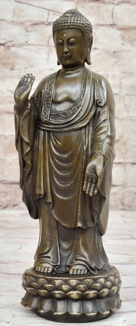 Buddha Bronze Sculptures: This unique work of art depicts a standing Buddha above a floating lotus flower. His left hand is holding up a blooming lotus flower while his right hand is unfolded and open, offering those who look