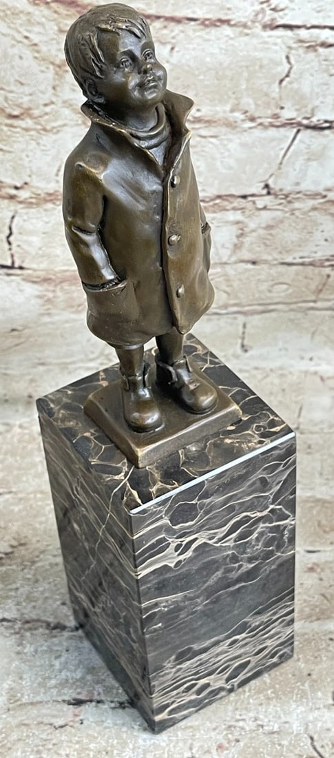 Boy Bronze Sculpture: A young boy ventures out into spring showers dressed in his long raincoat and boots. He peers up at the open grey sky and lets the raindrops wet his red cheeks. His coat is detailed with buttons and