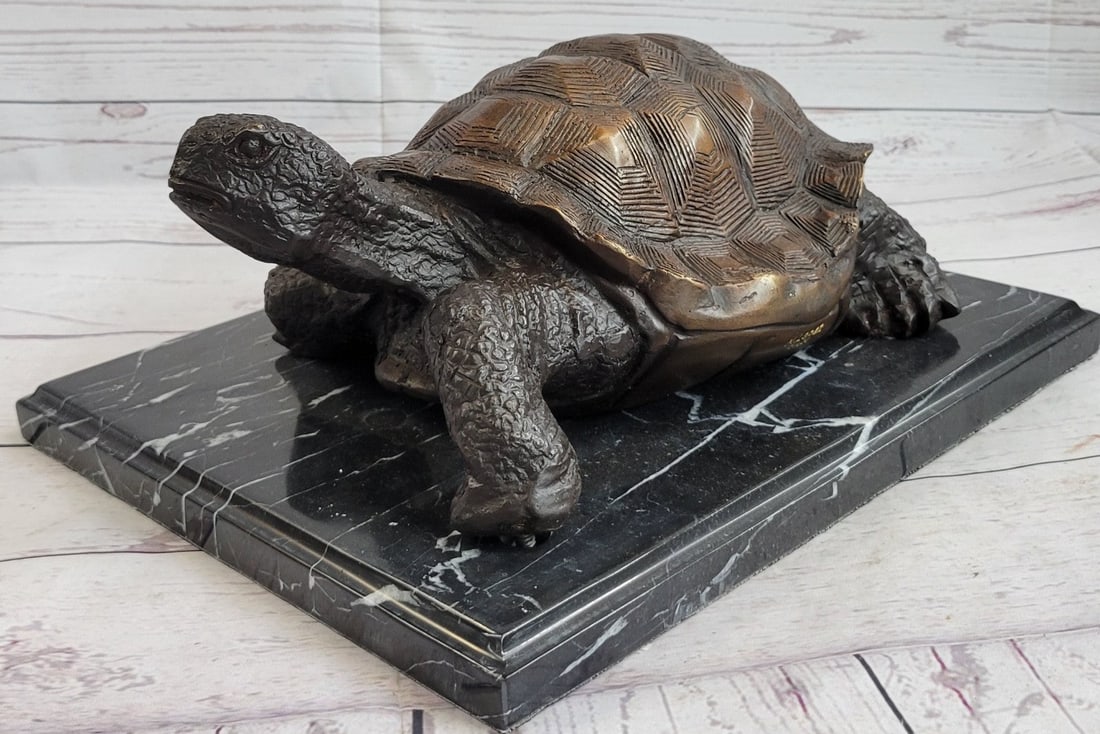Turtle Bronze Statue: This is a marvelous statue full of movement. It is a happy turtle journeying through the ocean and swimming upward. He seems to be anxious to reach the surface. His shell is detailed in a way that