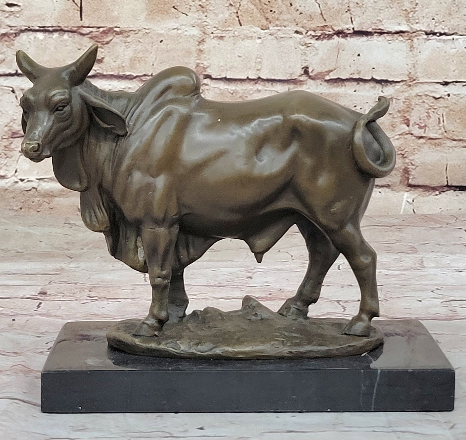 Cow Bronze Sculpture: Zebu Bose primogeniture indices or Boas indicus, sometimes known as humped cattle, indicus cattle, Cebu, or Brahman cattle are a type of domestic cattle originating in South Asia, particularly the Ind