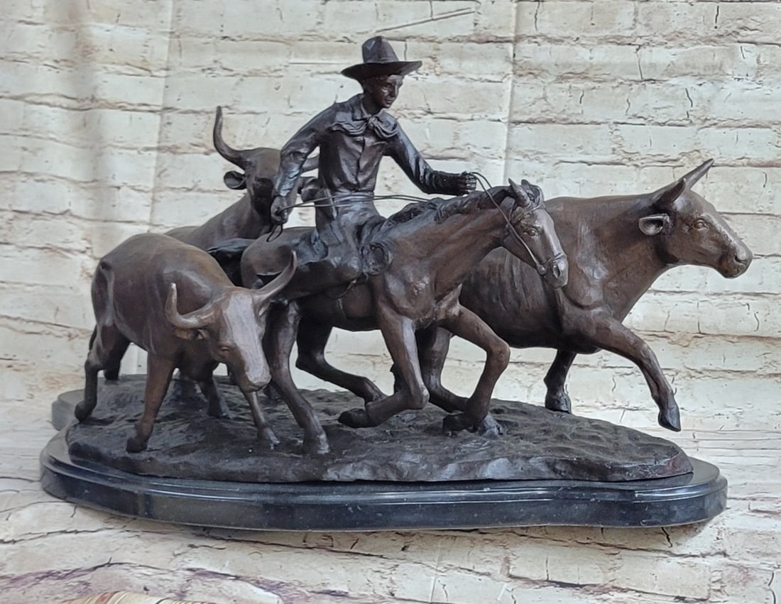 A lone cowboy Bronze Sculpture: A lone cowboy sets out on a long journey. His loyal horse slowly navigates the rough terrain carefully. The cowboy sits tall and clutches the reins while guiding a herd of bulls. His hat sits low on