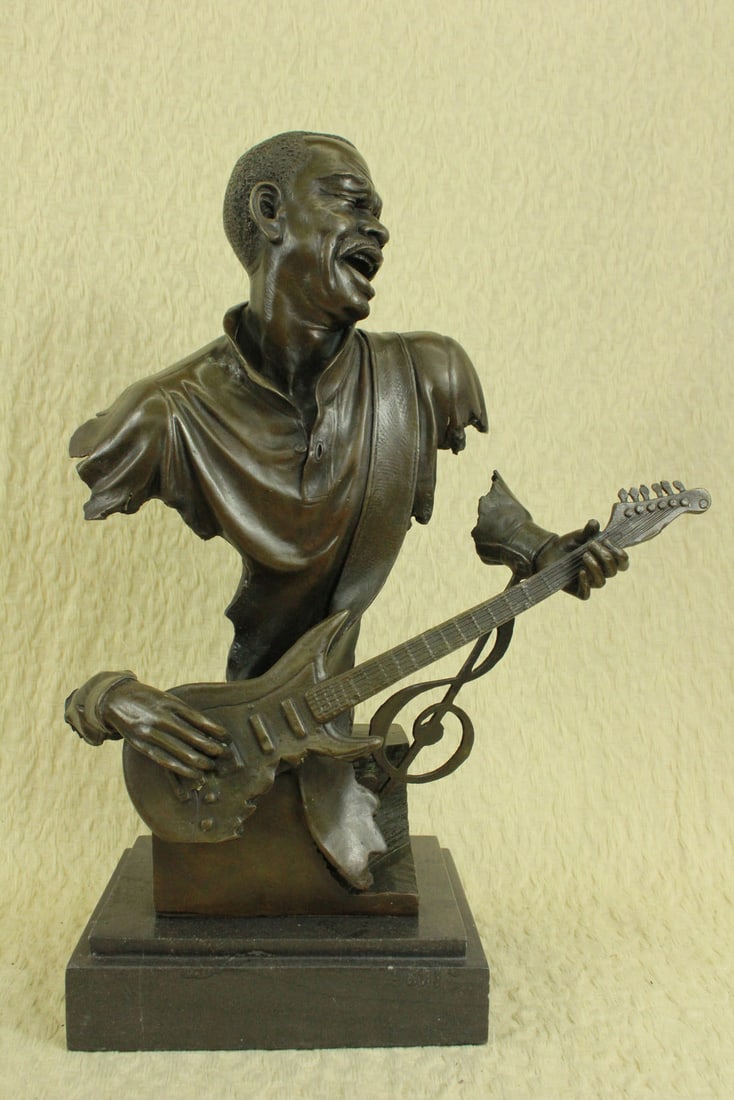 Music Musician Guitar Player Bronze Statue: A handsome bronze statue of a Musician playing the Guitar. Felt covered underside on the marble base. This bronze sculpture was cast using the ancient method of lost-wax casting and stained with a