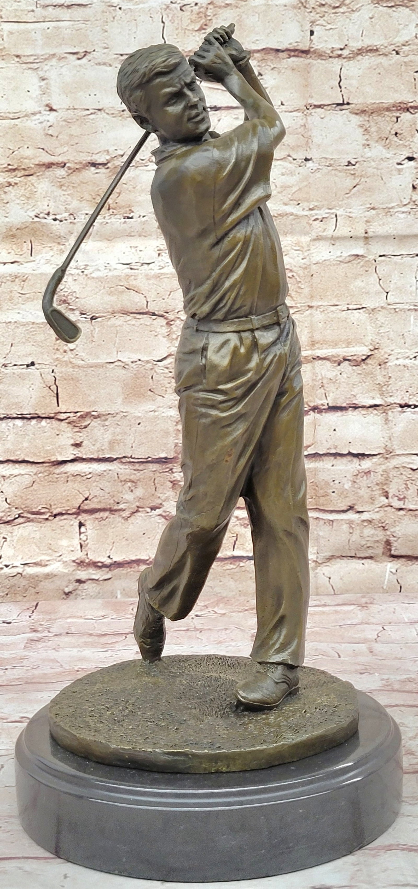 Golfer Trophy Bronze Statue: He watches his golf ball fly high over the rough and into the green. It is the epitome of the perfect swing. He holds his pose as he watches his ball make its way to the hole. His arms are right-angle