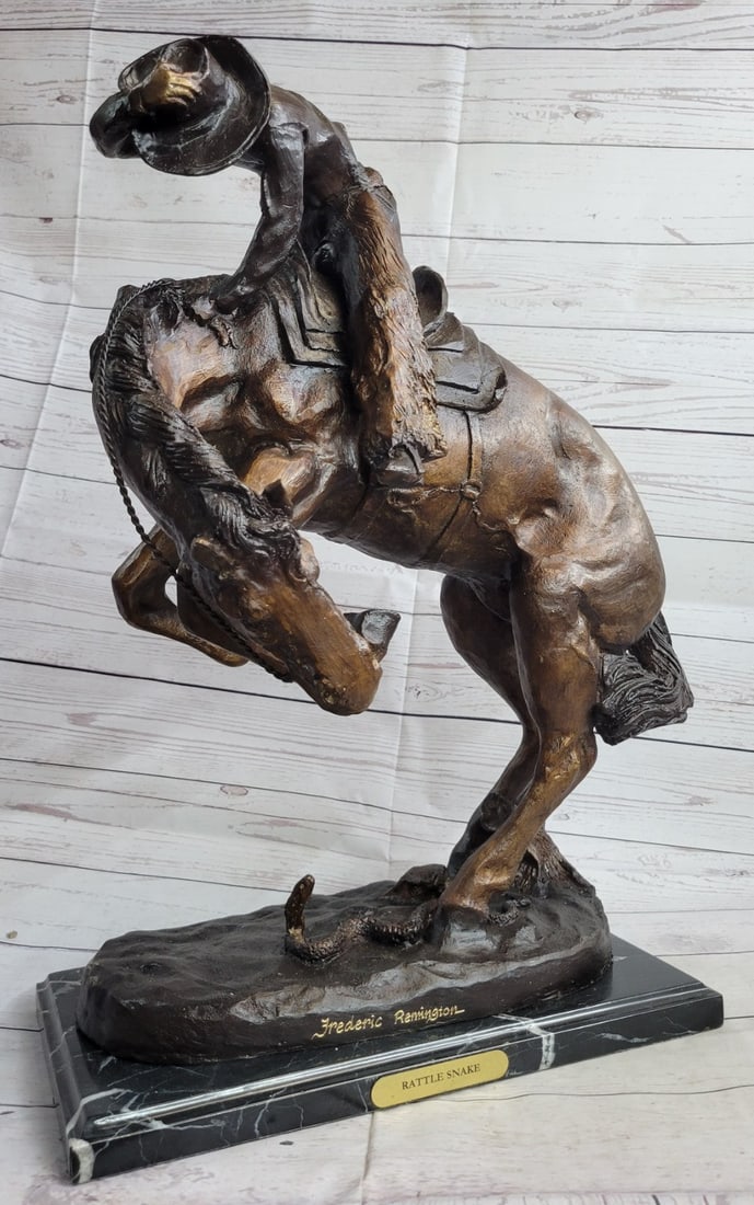 Cowboy on horse batteling a Rattle Snake Bronze: A leisurely trot in the desert turns deadly when a rattlesnake spooks a horse. The cowboy is bucked by his uncontrollable stallion. He attempts to hold on as long as he can but his body lifts from the