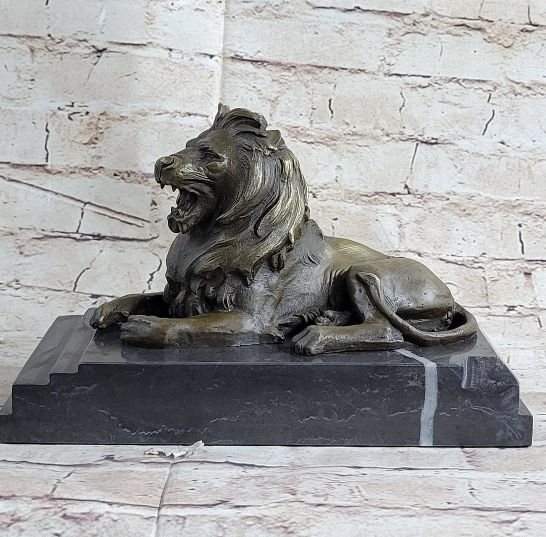 African Lion Bronze Sculpture: He is angry, hungry, and unrelenting. The lion paws grip the ground, the tension spreads like a current from his paws to all the tendons in his body. His mouth is open wide in what can only be a feroc