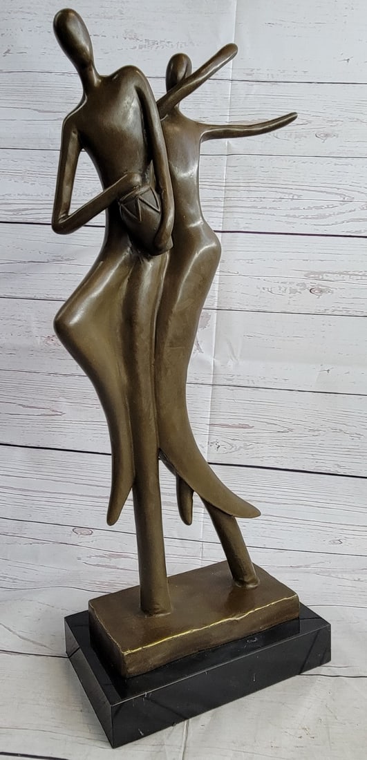 Couple Bronze Sculpture: The suggestive male figures symbolize the rejoice of the soul through the expression of music. The leading figure keeps a rhythm on his bongo while the other sways and dances to the song of the