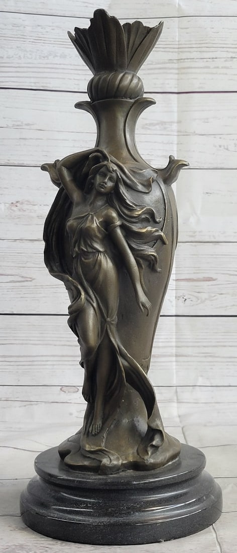 Woman Bronze Sculpture: This is a Bronze Statue of a Sexy Woman on a marble base. Sensual gorgeous women lean against a wall with every curve defined in vivid detail. Her slender long arms are extended, as she stares seducti