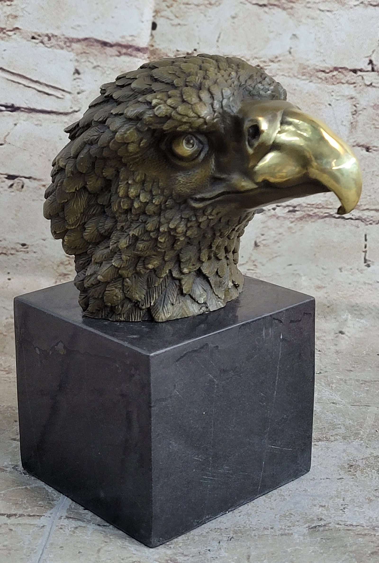 Eagle Bronze Sculpture: The bust of the eagle head captures the essence of the majestic bird of prey. The eagle very large hooked beak (coated in a gold patina) is used for tearing flesh from their unfortunate prey. The extr