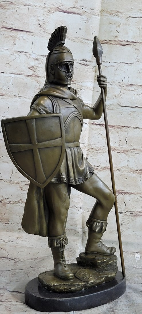 Roman God of War Warrior Bronze Sculpture: The Roman Warrior stands with his left leg resting on a rock and the other one holding his stance, as he wears his armor he thinks about all the things he had to do to get where he is. He stands
