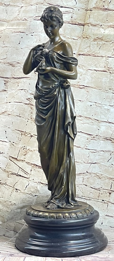 Maiden gets in touch with Nature Bronze Sculpture: A young maiden gets in touch with nature taking a young bird in her hands. She stares at this beautiful animal with wonder without realizing her beauty is a joy to be gazed at as well. This bronze scu