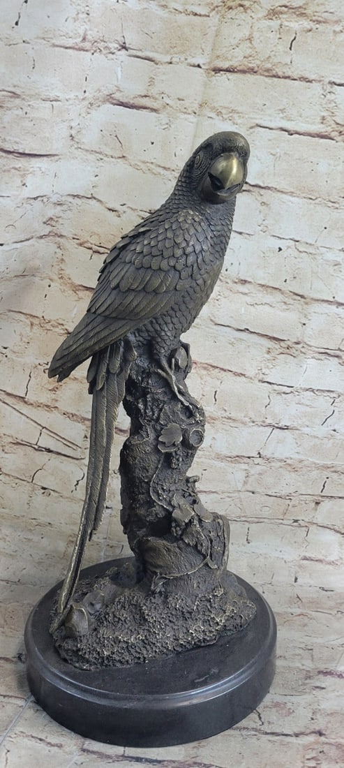 Parrot on Tree Bronze Sculpture: This beautiful Brazilian parrot is unique for all you bird lovers. Some birds, especially corvids and parrots, are among the most intelligent animal species. He is?sitting up on top a tree trunk.