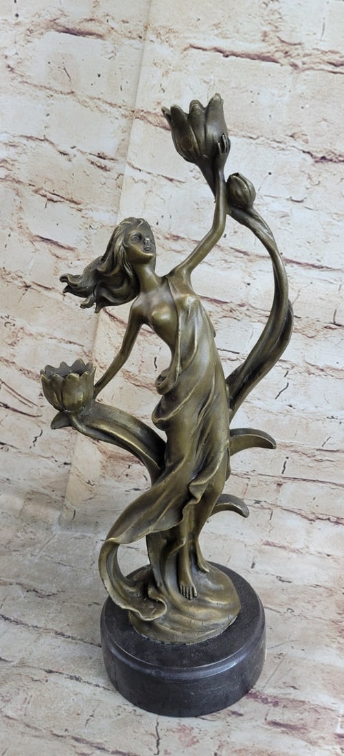 Sexy Nymph with Tulip Candle Holder Bronze Sculpture: This gorgeous candle holder depicts a woman relaxing as she wipes the sweat from her forehead. She places one hand behind her?and exudes beauty from her inner being. She is dressed in a gorgeous