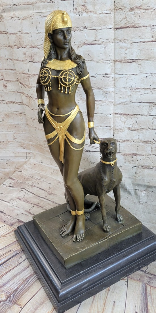 Egyptian Queen and Panther Bronze Sculpture: This beautiful sculpture of an Egyptian Queen is gorgeous and has amazing details. She stands in a very sexy position and she wears a little skirt fitted tightly to her waist and thighs. She is bare f
