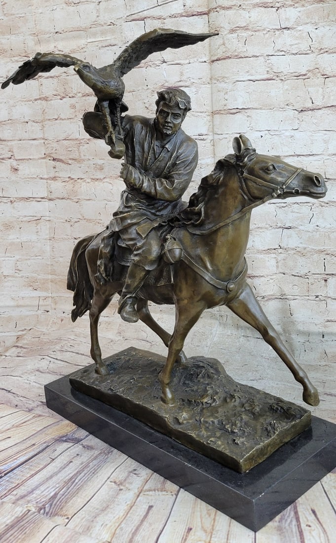 Man Horse Eagle Hunting Bronze Sculpture: A man trotting through the fields on his faithful horse has attached his quarry to the side of his saddle on his horse and he looks around for more game to hunt. He looks like he lives in the wild